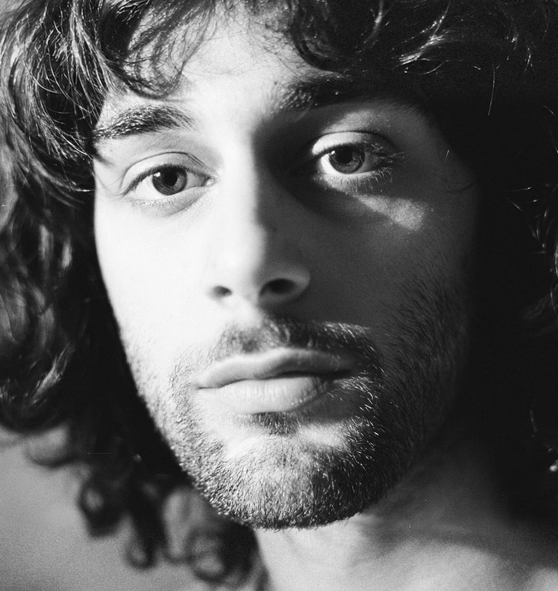 Giorgi Dzidziguri, a close black and white portrait, half his face in light